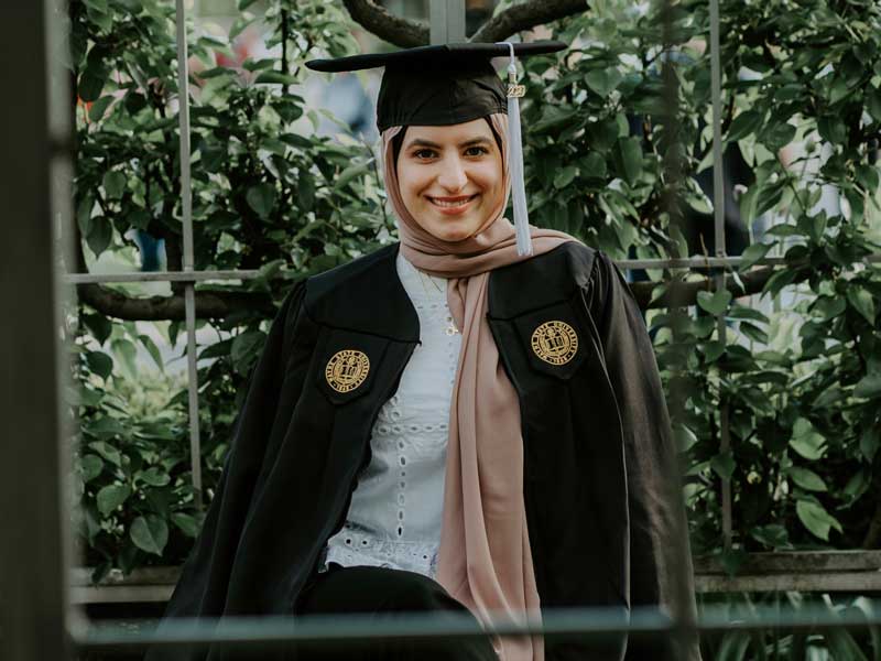a college graduate dressed in commencement regalia